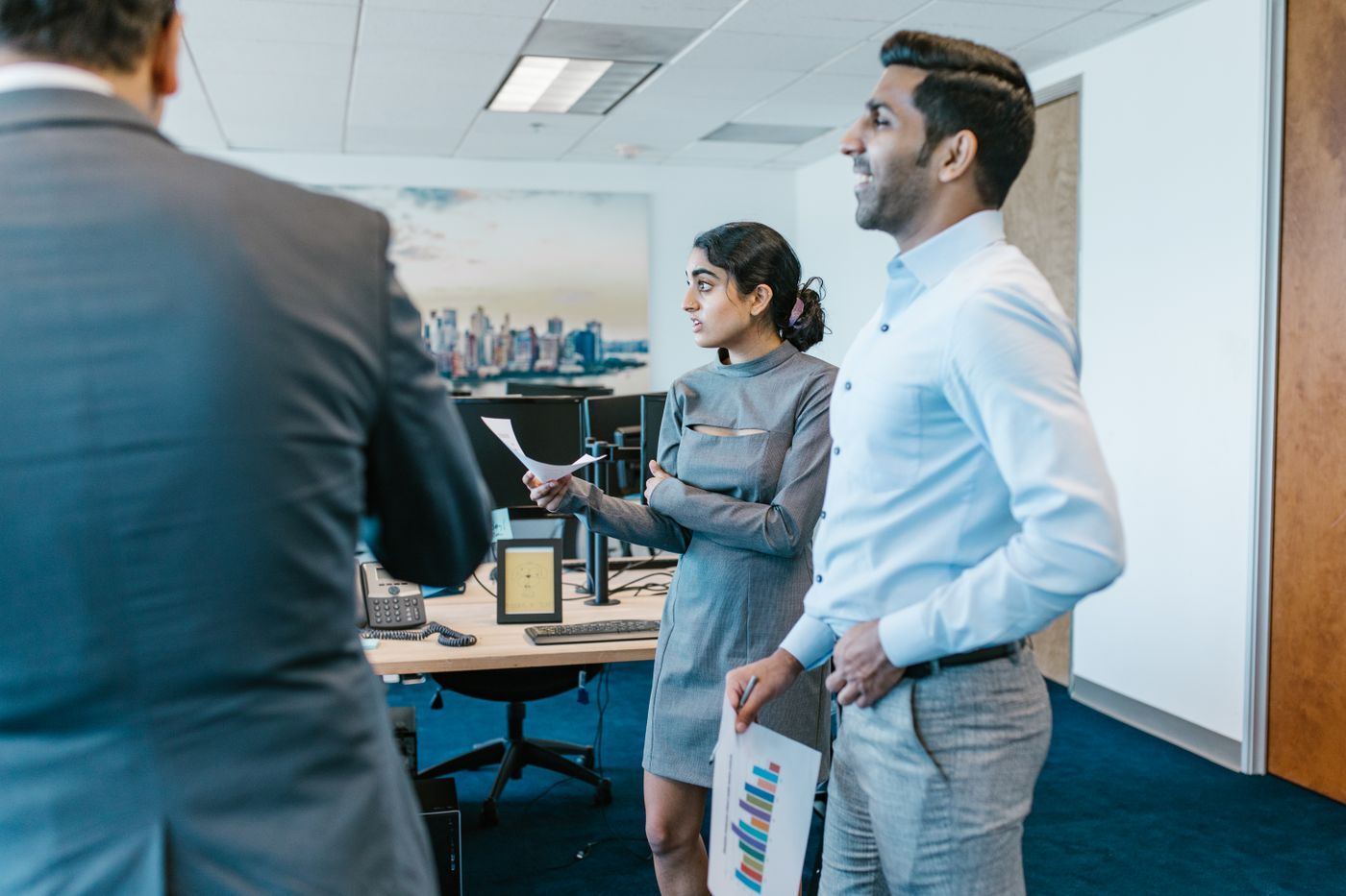 Colleagues discussing work in an office